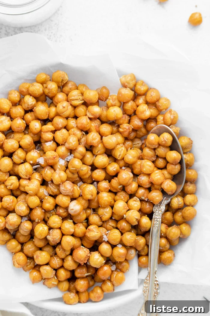 crispy chickpeas on a white plate with a spoon on the side