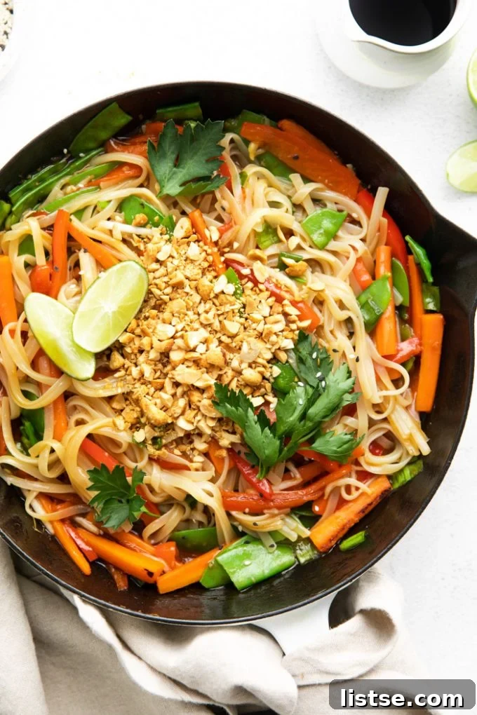 Vibrant vegan Pad Thai dish in a large skillet, ready to be served