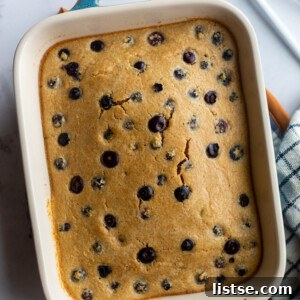 Baked Oats Double the Delight 6 baked oats with blueberries in a small casserole dish with a napkin and spoons on the side