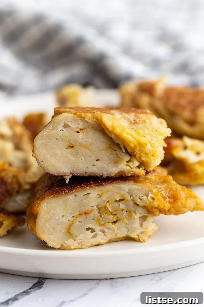 Viral Seitan Sensation 2 Cooked seitan, sliced in half and stacked, resembling cooked chicken breast pieces, showcasing its firm and meaty texture.