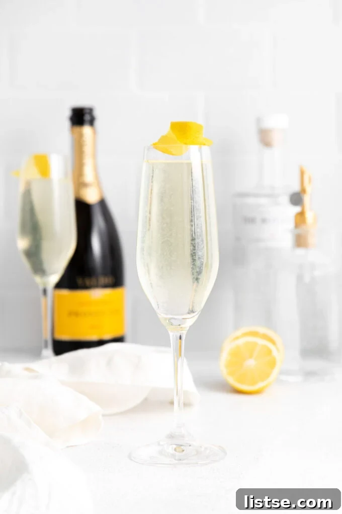 Classic French 75 cocktail garnished with a lemon twist, a refreshing gin and champagne drink