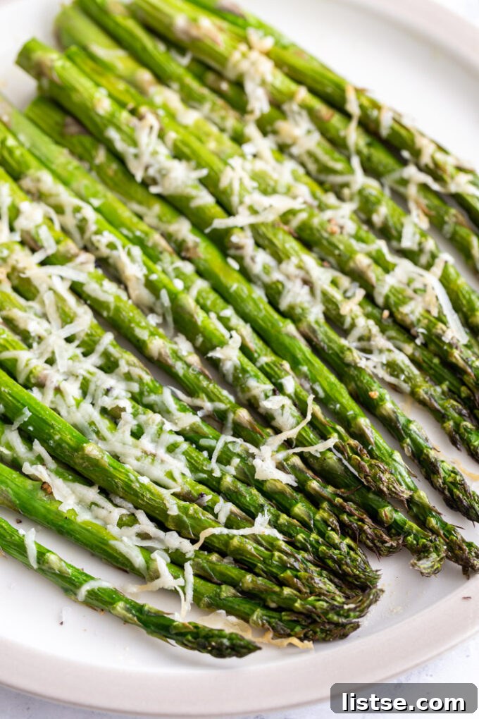 Close-up of air fryer asparagus garnished with grated parmesan cheese