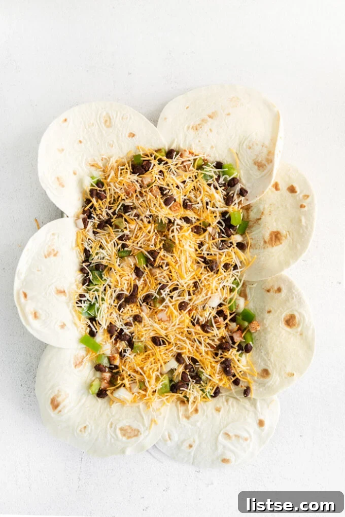 Step-by-step image showing the filling spread evenly over the tortillas on the sheet pan.