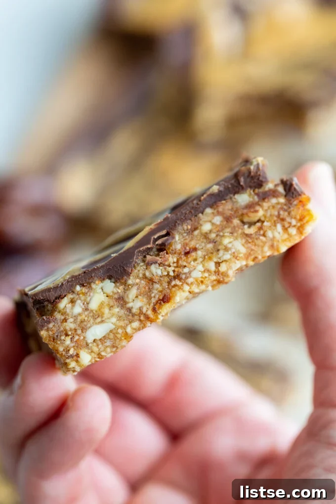 side shot of a date nut bar that has chocolate on the top