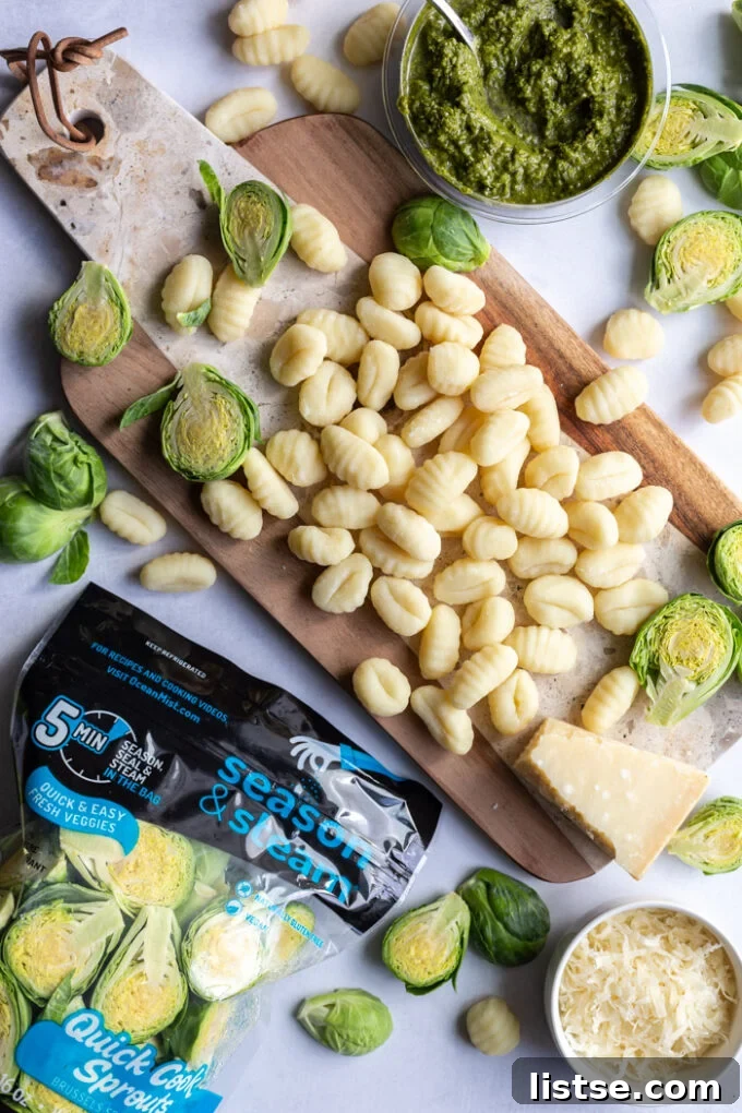 Vibrant Brussels Sprouts Pesto Gnocchi 3 Various ingredients for Pesto Gnocchi with Brussels Sprouts on a wooden board, including a package of Ocean Mist Quick Cook Sprouts.