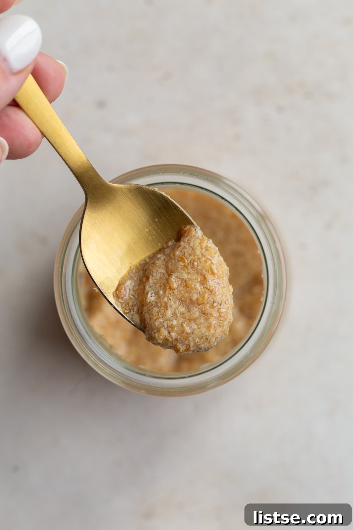 A close-up shot of a spoonful of flax egg mixture, showcasing its gel-like consistency.