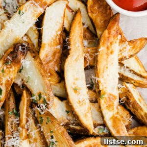 air fryer potato wedges topped with parsley and parmesan