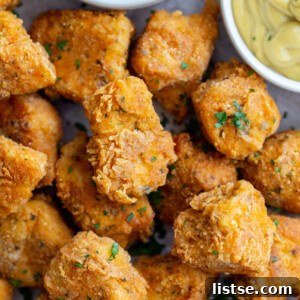 crispy tofu nuggets on a tray with ketchup and mustard in the corner of the shot