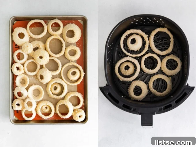Close-up of breaded onion rings neatly arranged in an air fryer basket, ready for cooking.