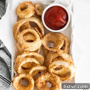 Air fryer onion rings served with ketchup