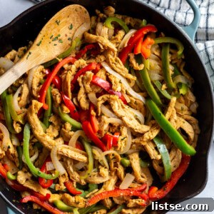 soy curls fajitas with soy curls and sauteed onion and green + red bell pepper in a large cast iron skillet