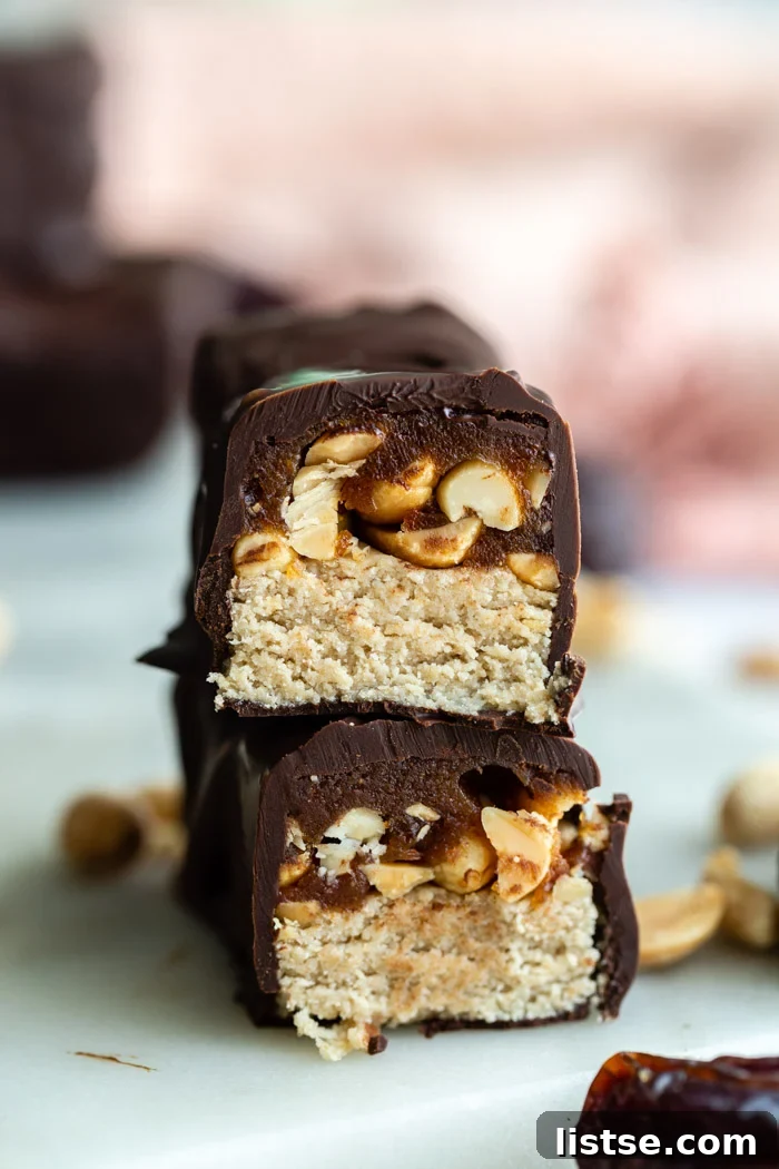 Delicious homemade Snickers bars, showcasing their irresistible layers of chocolate, caramel, and nougat.