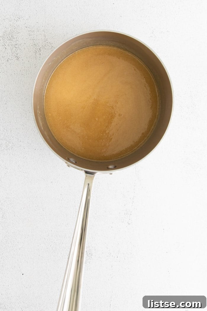 A saucepan filled with a melted sugar and butter mixture