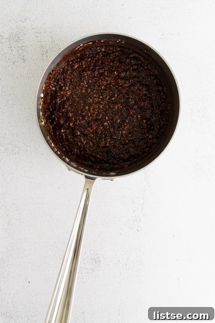 A saucepan with the chocolate and oat mixture being stirred