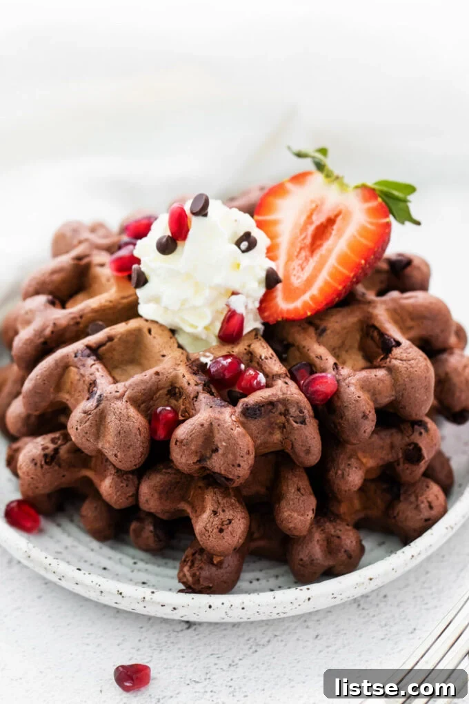 Decadent Chocolate Waffles 2 chocolate waffles topped with whipped cream and strawberries