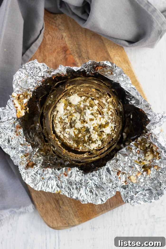 unwrapping foil from baked artichoke