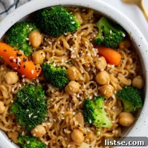 up close shot of ramen noodles with veggies and sprinkled with sesame seeds