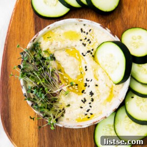 Baba Ganoush with a slice of cucumber dipped in
