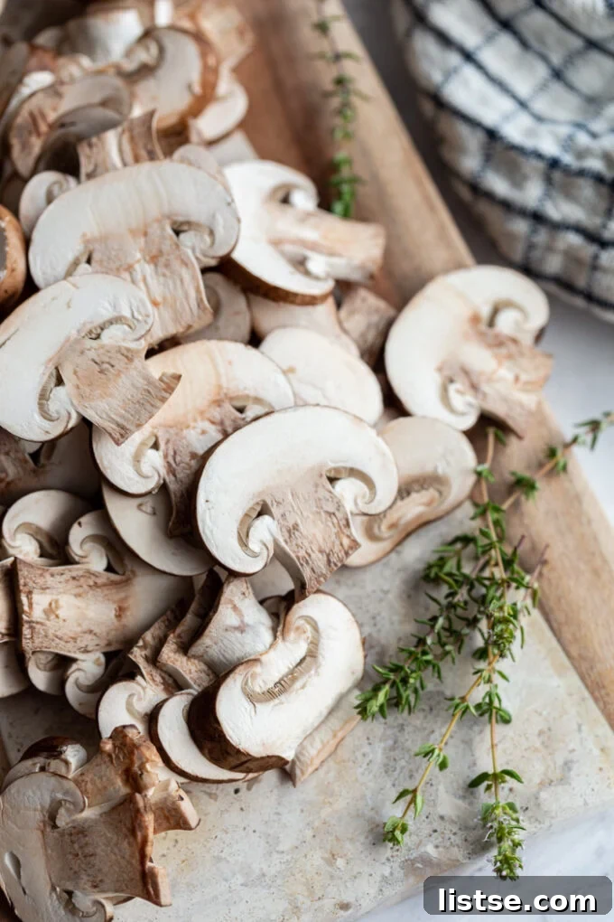 sliced mushrooms on a wooden cutting board