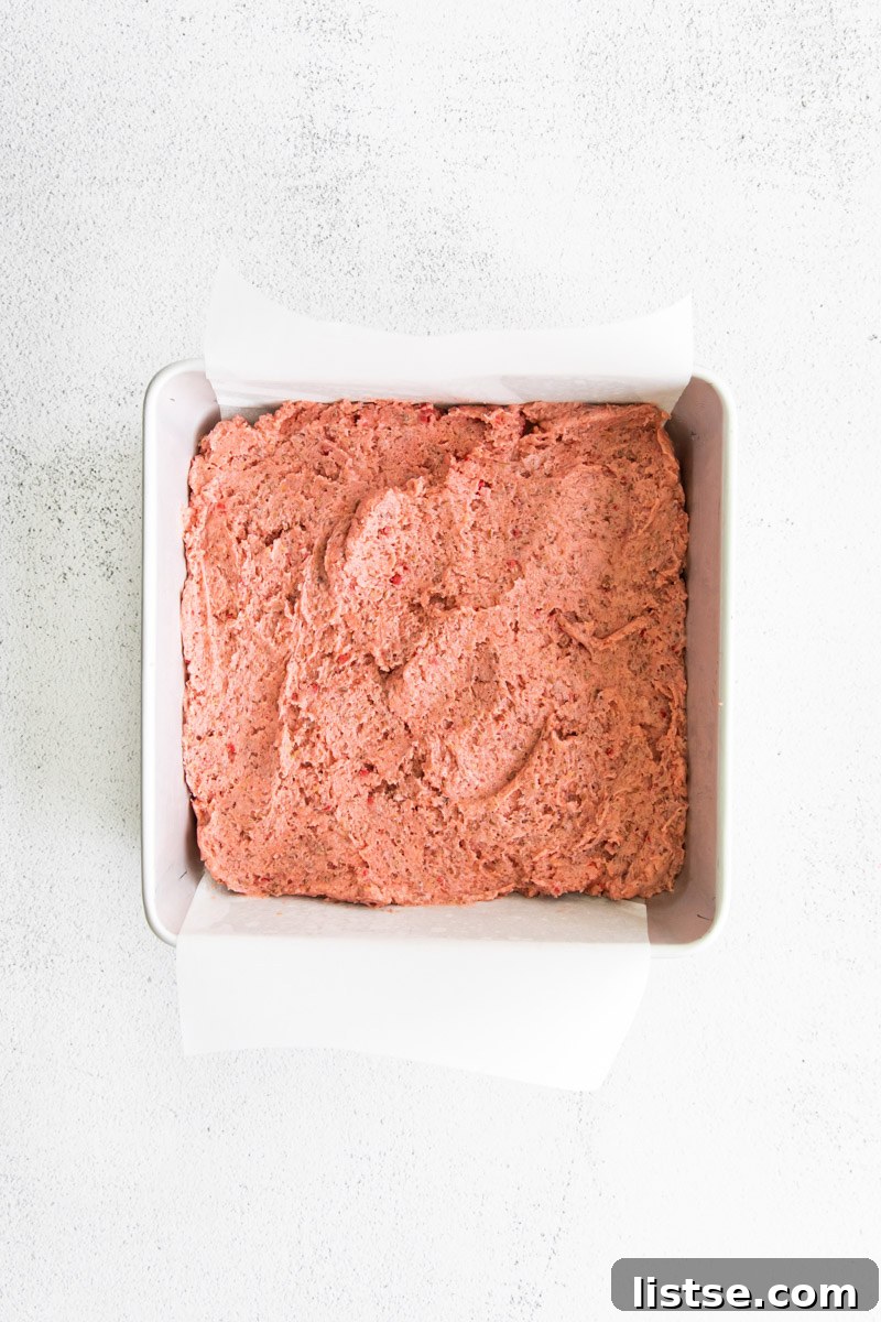 Strawberry Chocolate Bliss 7 Thick, pink strawberry brownie batter pressed into a small baking pan.
