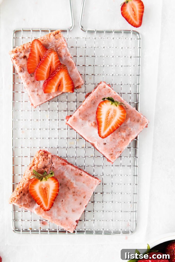Strawberry Chocolate Bliss 9 Delicious pink strawberry brownies topped with fresh strawberry slices and a drizzle of glaze.