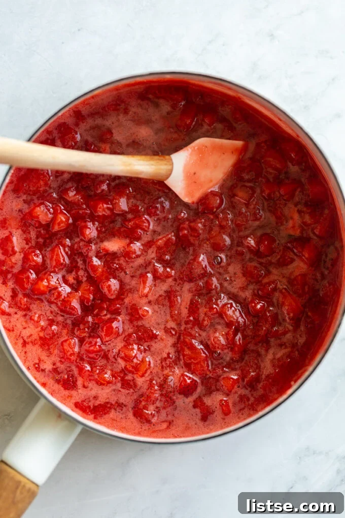 Another perspective of the strawberry puree, highlighting its smooth consistency and glistening surface in the pot.