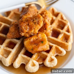 waffle on a white plate topped with vegan chicken nuggets