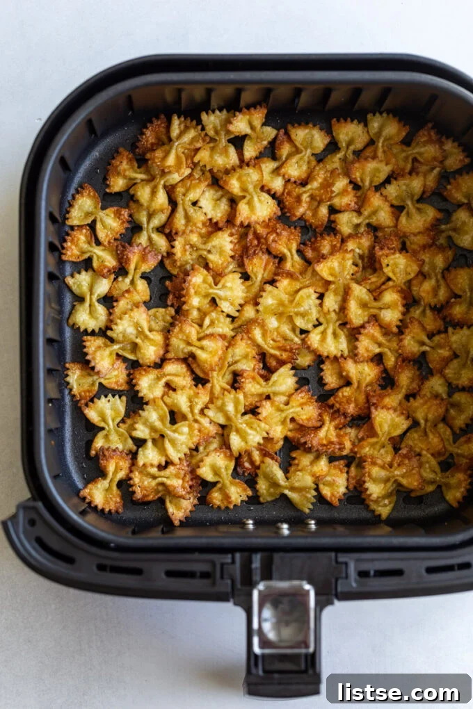 Crispy Pasta Bites 3 Air fryer pasta chips being prepared in an air fryer basket