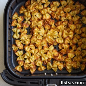 Air fryer pasta chips in an air fryer basket, ready to eat