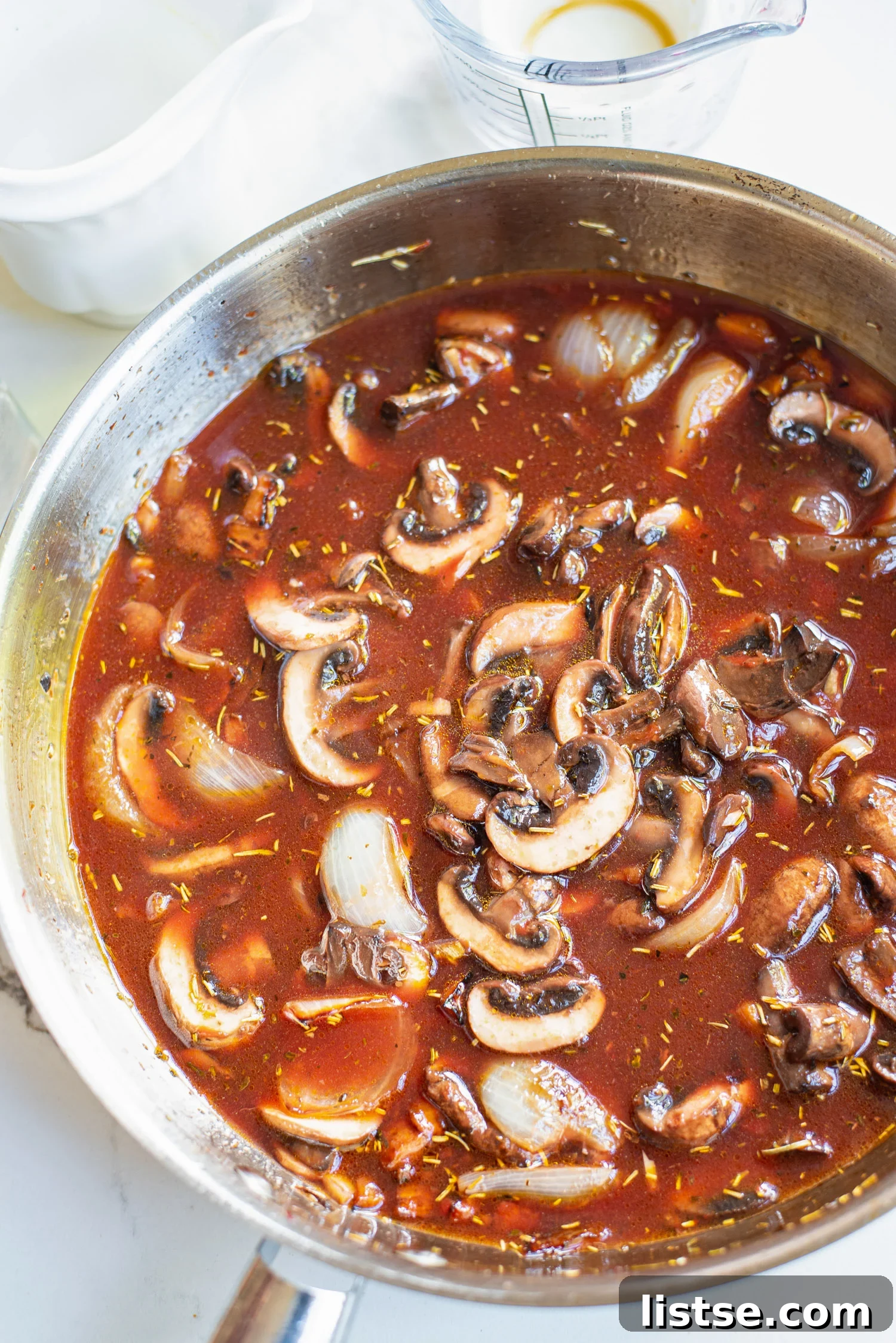 Simmering mushrooms Bourguignon in a skillet
