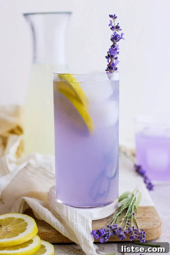 A refreshing glass of lavender lemonade, garnished with fresh lemon slices and a lavender sprig, ready to be enjoyed.