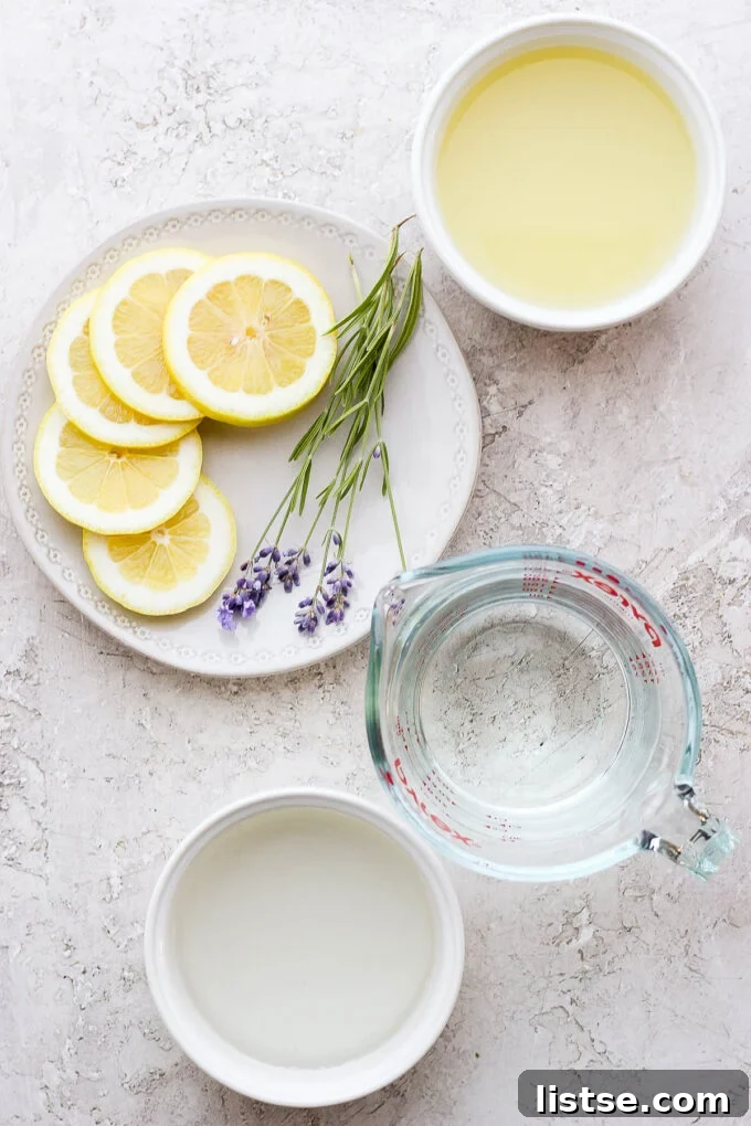 Ingredients laid out for making lavender lemonade, including fresh lemons, dried lavender, water, and simple syrup.