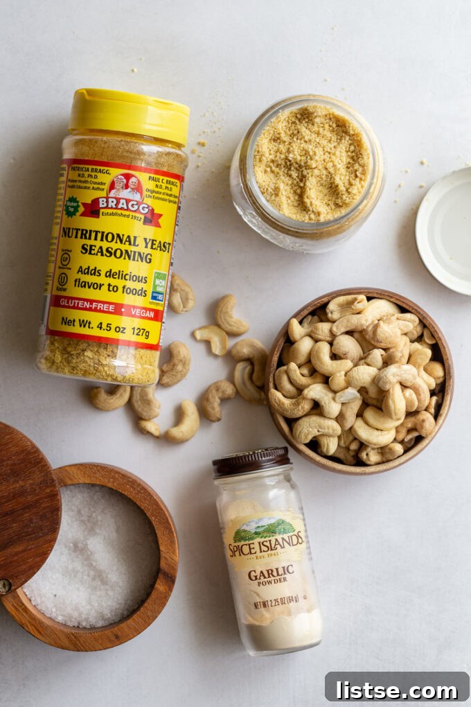ingredients for vegan parmesan cheese including nuts, nutritional yeast, garlic powder, and salt