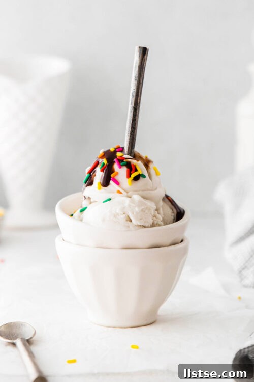 Culinary Delights Beginning with I 2 A vibrant bowl of ice cream, generously topped with colorful sprinkles and a rich drizzle of chocolate sauce, ready to be enjoyed.