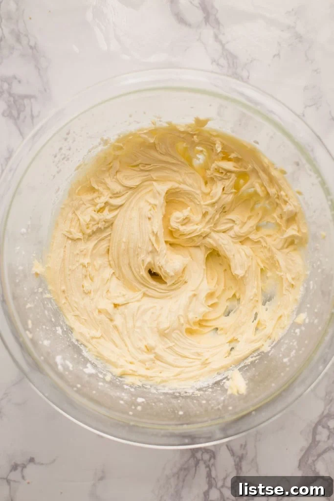 Culinary Delights Beginning with I 5 Close-up shot of smooth, white frosting in a clear glass bowl, ready for use.