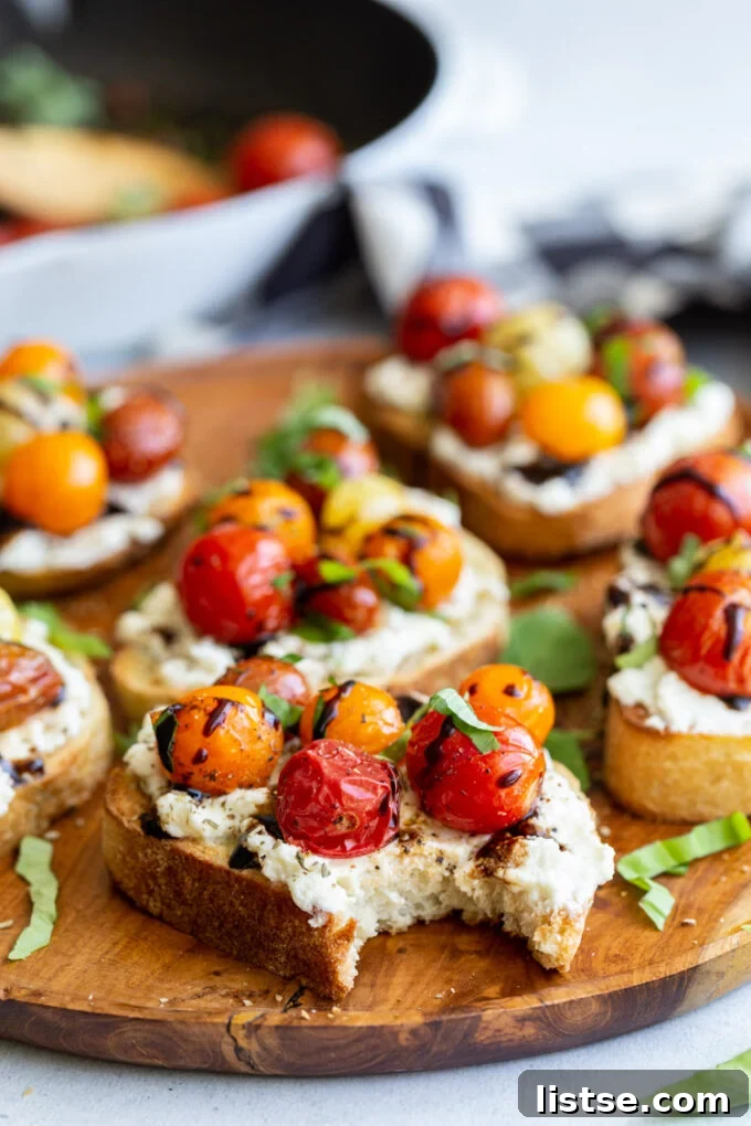 Close-up shot of a single slice of ricotta toast, showcasing its texture and colorful toppings.