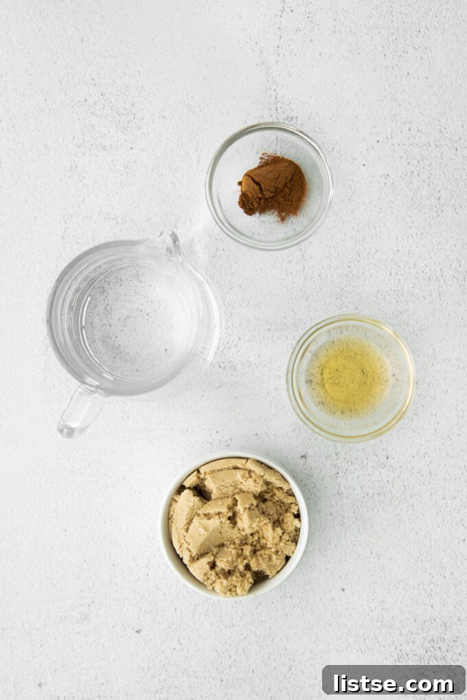 All the simple ingredients laid out for making the Starbucks Iced Brown Sugar Oatmilk Shaken Espresso copycat: espresso, oat milk, ice, and brown sugar syrup ingredients.