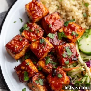 A beautifully arranged BBQ Tofu Bowl with quinoa and coleslaw, showcasing fresh ingredients.