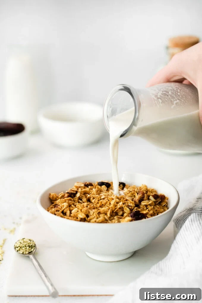pouring hemp milk into a bowl of cereal