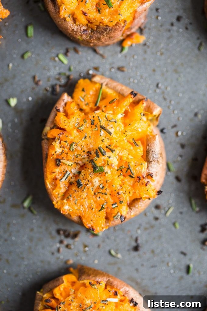 Y-Foods: A Tasty Exploration 2 Smashed sweet potato rounds on a baking sheet, topped with pepper and ready for baking. Sweet potatoes are often referred to as yams in North America.