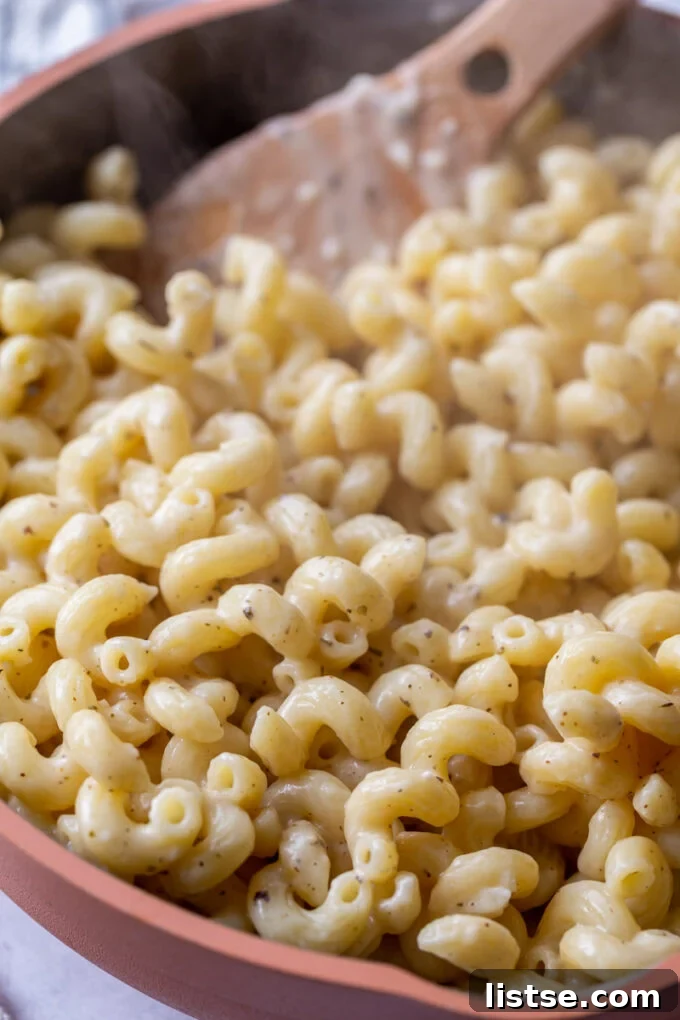 Velvety Cream Sauce Cavatappi 2 Cooking cavatappi pasta in a large skillet, ready to be tossed with sauce.