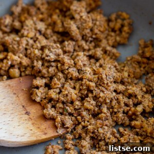 Rich and savory mushroom taco meat simmering in a vibrant pink skillet, captured from an overhead angle.