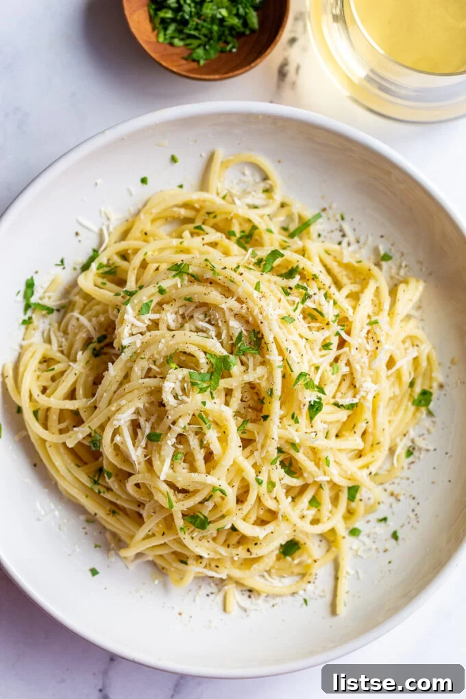 white wine pasta in a salad bowl topped with fresh herbs