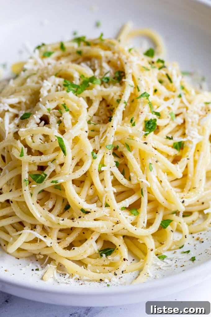 white wine pasta in a salad bowl topped with fresh herbs