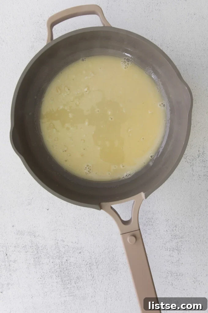 making a white wine sauce in a large skillet