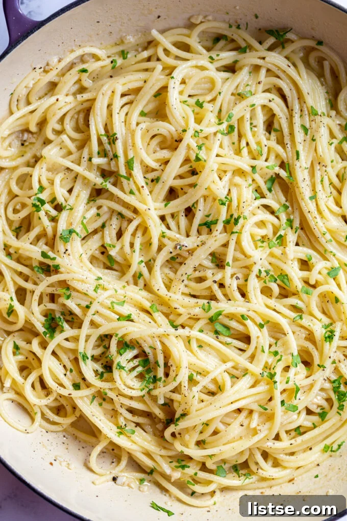 white wine pasta in a large skillet topped with fresh herbs
