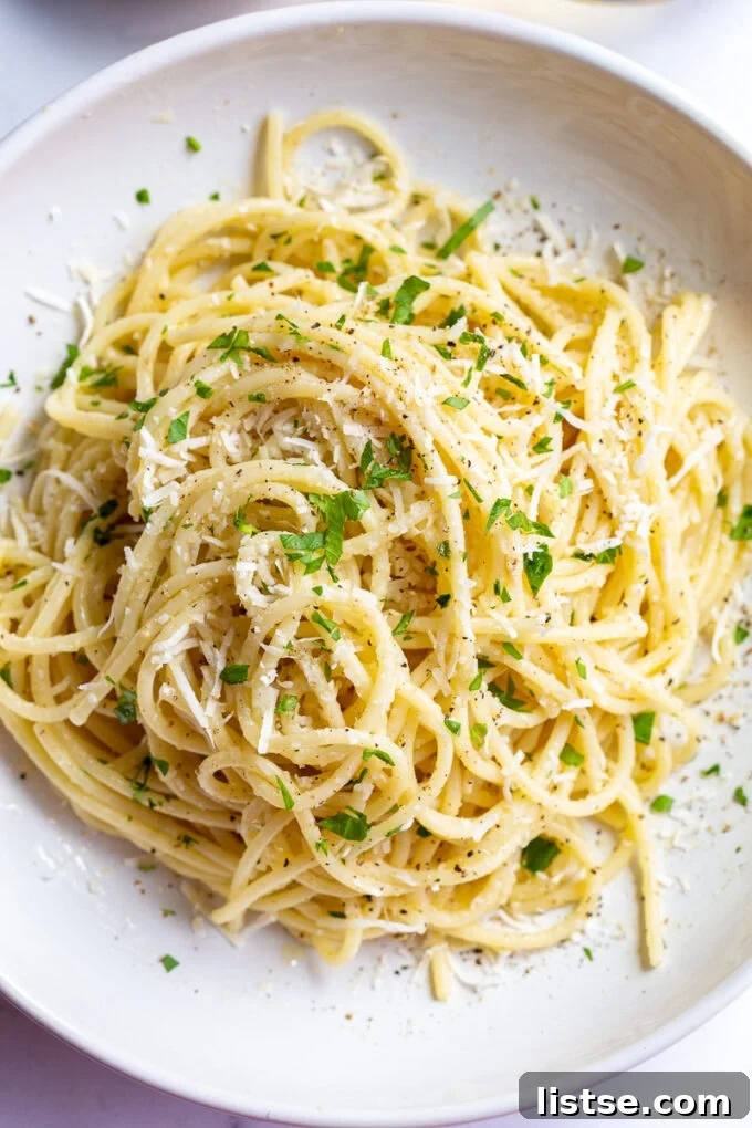 white wine pasta in a salad bowl topped with fresh herbs