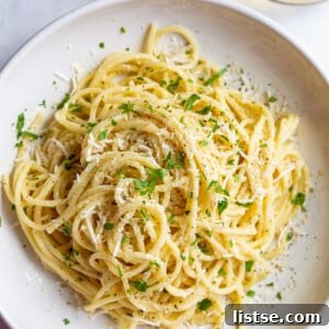 white wine pasta in a salad bowl topped with fresh herbs