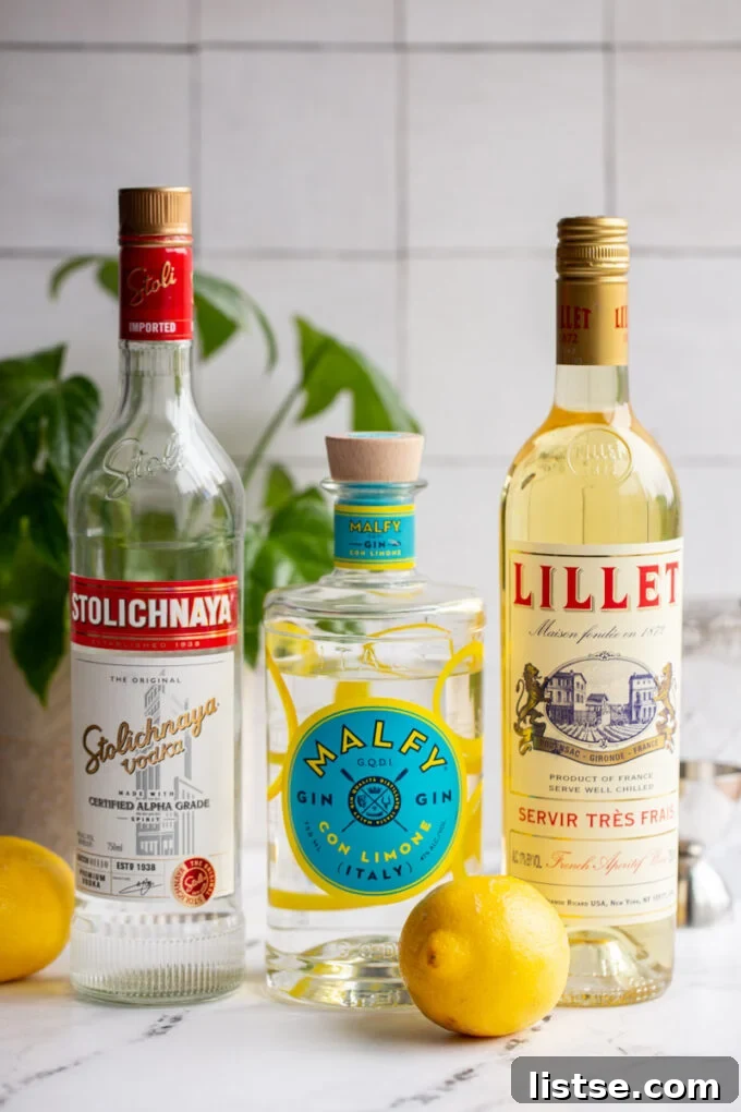 The three essential ingredients for a Vesper Martini: a bottle of premium gin, a bottle of high-quality vodka, and a bottle of Lillet Blanc, poised to create a classic cocktail.