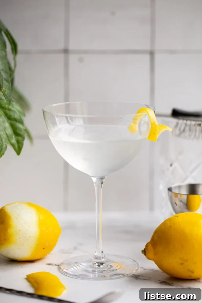 A Vesper Martini, expertly mixed and garnished with a lemon twist, reflecting light in a sophisticated cocktail glass, signifying a perfect pour.